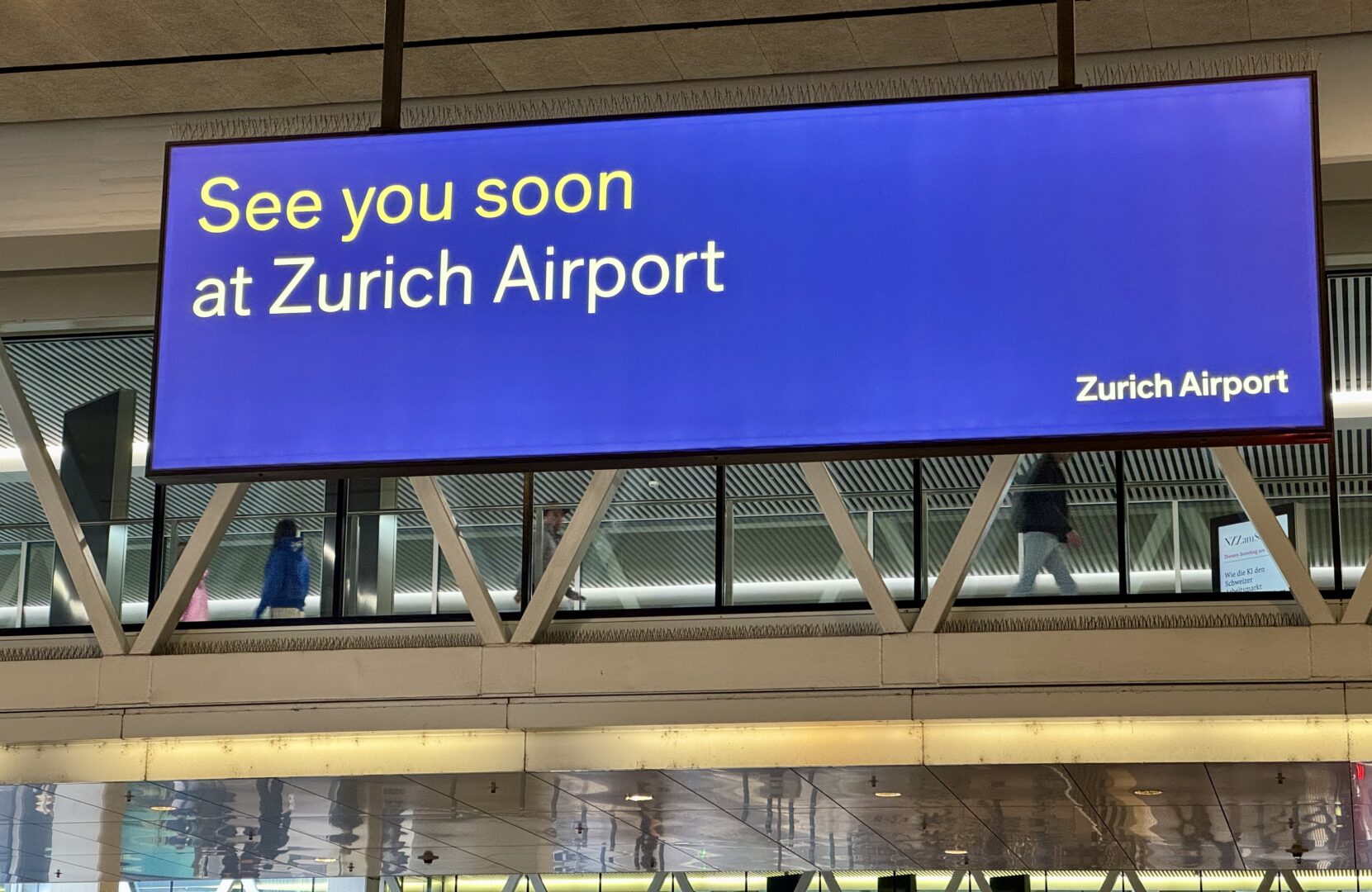 Zurich Airport departure gate with the iconic “See you soon” sign — captured by Globetransporte chauffeur service.