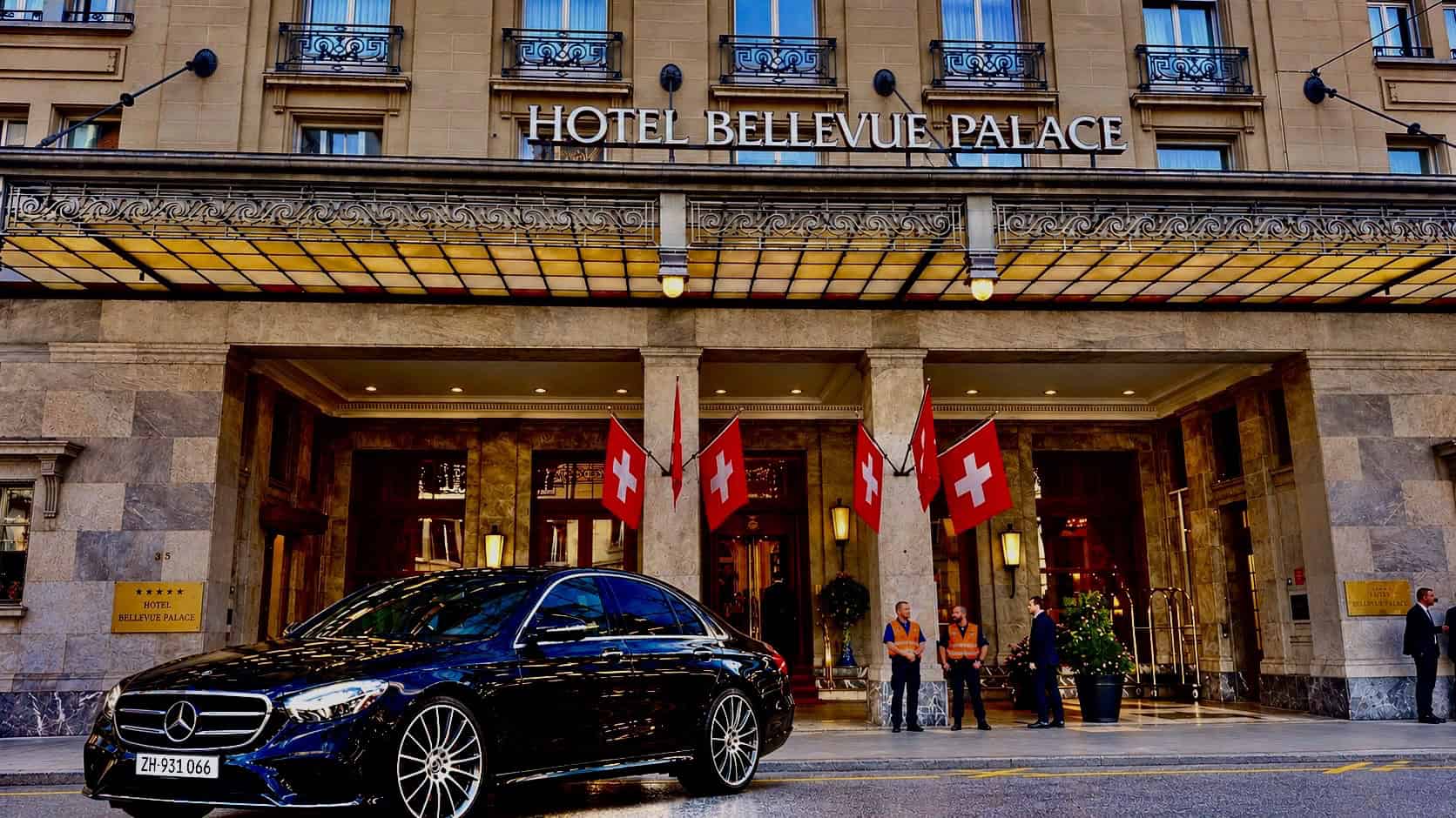 Globetransporte Mercedes-Benz S-Class 500 parked at Hotel Bellevue Palace Bern after a Zurich Airport transfer, with Swiss police in the background
