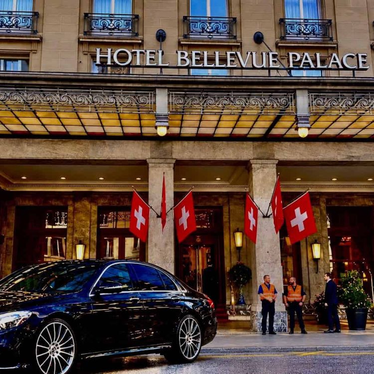 Globetransporte Mercedes-Benz S-Class 500 parked at Hotel Bellevue Palace Bern after a Zurich Airport transfer, with Swiss police in the background