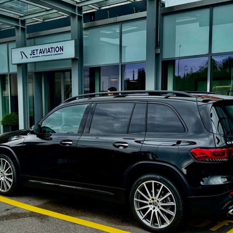 Black Mercedes-Benz GLB SUV parked outside Jet Aviation facility, highlighting premium vehicle fleet for executive and corporate transportation services.