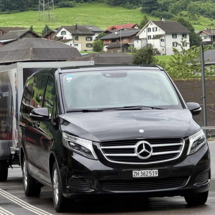 Mercedes V-Class towing luggage trailer for private group transfer in Zurich by Globetransporte GmbH