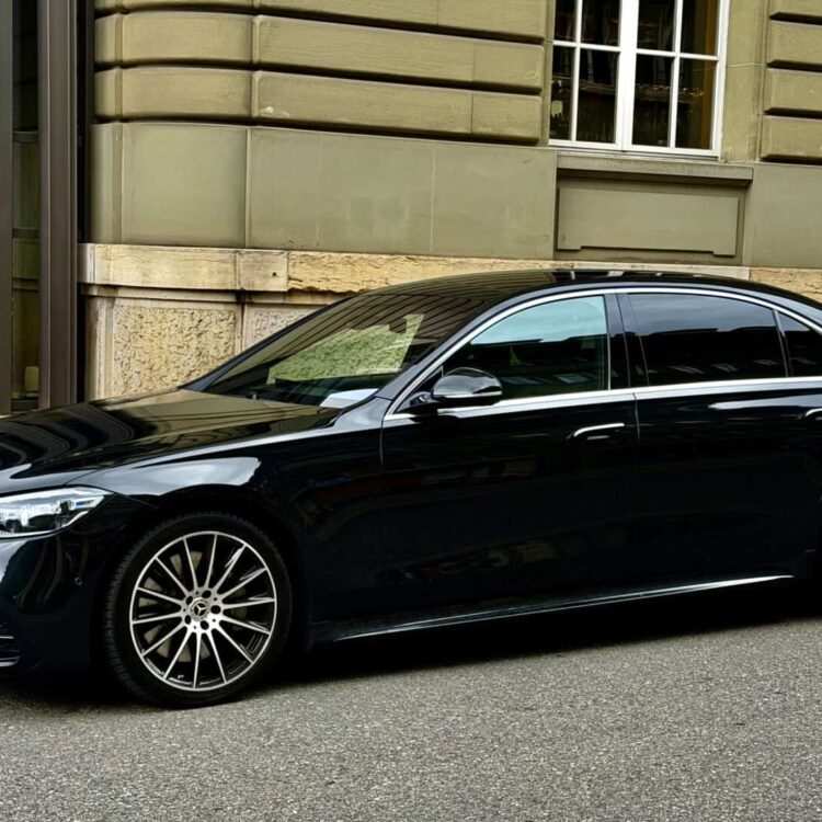 S Class Luxury black sedan parked on city street, ideal for corporate and executive transportation services. Elegant, comfortable, and reliable vehicle for professional clients.