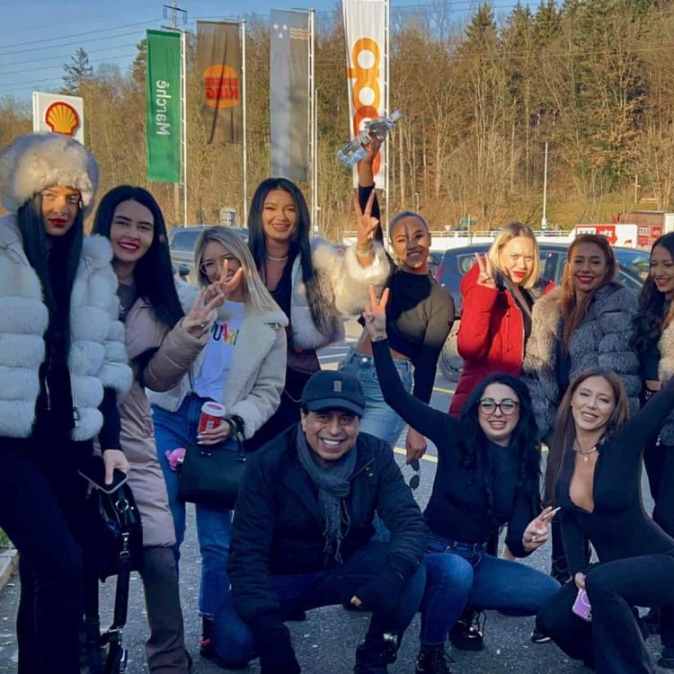 Group of diverse professionals celebrating outdoors near Globetransporte office, showcasing teamwork and company culture in a vibrant, professional environment.