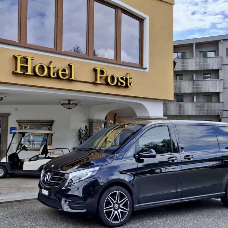 Luxury Mercedes black car for 7 passengers in front of Hotel Post am See, Austria, arriving from Zurich Airport